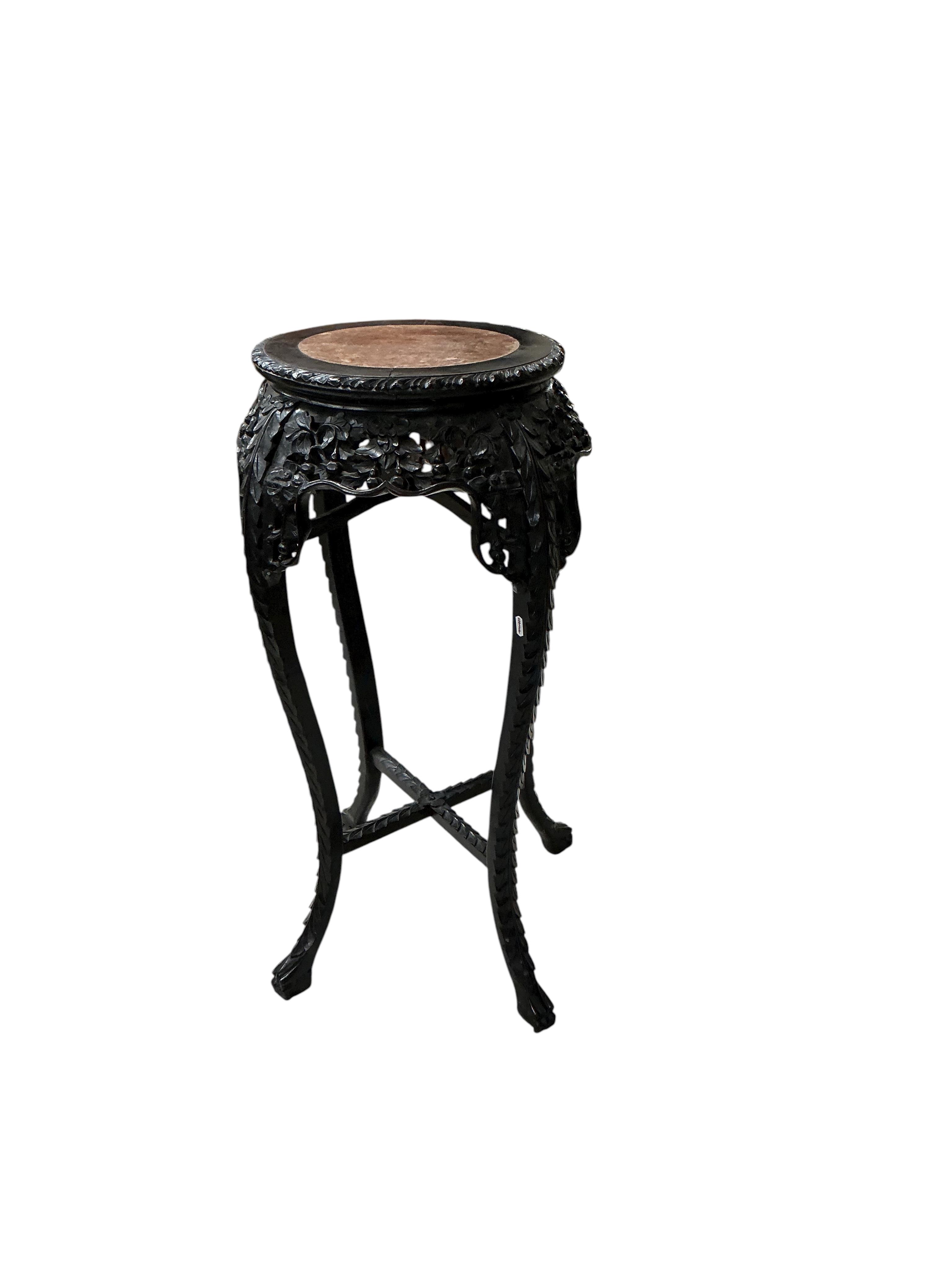 A Chinese circular rouge marble topped carved hardwood vase stand, diameter 44cm, height 91cm
